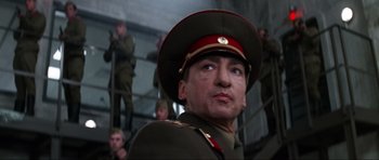 Movie still from “GoldenEye” (1995), directed by Martin Campbell – A person wearing a military uniform; Close Up shot, Low angle