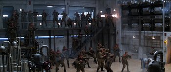 Movie still from “GoldenEye” (1995), directed by Martin Campbell – A group of men in military uniforms are standing in front of a staircase; Extreme Wide shot, High angle