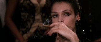 Movie still from “GoldenEye” (1995), directed by Martin Campbell – A person holding a cigarette in her mouth; Close Up shot, Over the shoulder angle