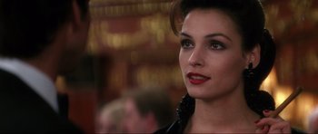 Movie still from “GoldenEye” (1995), directed by Martin Campbell – A person wearing a black dress; Close Up shot, Over the shoulder angle