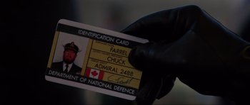 Movie still from “GoldenEye” (1995), directed by Martin Campbell – A person holding a canadian identification card; Extreme Close Up shot, Overhead angle