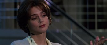 Movie still from “GoldenEye” (1995), directed by Martin Campbell – A woman wearing a headset looking to her left; Close Up shot, Over the shoulder angle