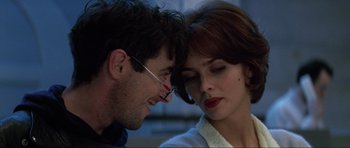Movie still from “GoldenEye” (1995), directed by Martin Campbell – A man and a woman looking at one another; Close Up shot, Low angle