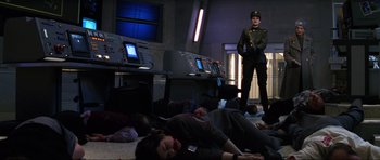 Movie still from “GoldenEye” (1995), directed by Martin Campbell – A group of people laying on the ground in front of a computer; Wide shot, Low angle