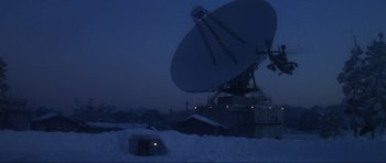 Movie still from “GoldenEye” (1995), directed by Martin Campbell – A large satellite dish sitting on top of snow covered ground; Extreme Wide shot, Low angle