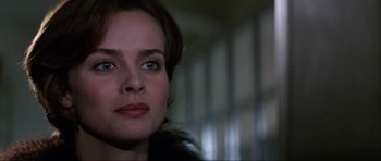 Movie still from “GoldenEye” (1995), directed by Martin Campbell – A woman's face in a dark room; Close Up shot, Over the shoulder angle
