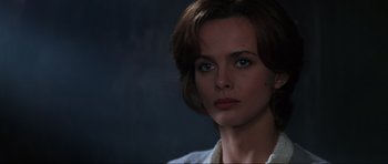 Movie still from “GoldenEye” (1995), directed by Martin Campbell – A person wearing a white shirt; Close Up shot, Over the shoulder angle