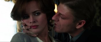 Movie still from “GoldenEye” (1995), directed by Martin Campbell – A man and a woman kissing in front of a window; Close Up shot, Over the shoulder angle