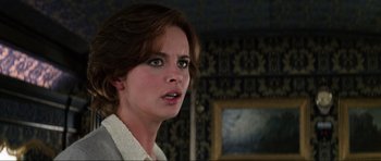 Movie still from “GoldenEye” (1995), directed by Martin Campbell – A person with short brown hair; Close Up shot, Over the shoulder angle