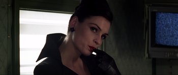 Movie still from “GoldenEye” (1995), directed by Martin Campbell – A woman with red lipstick and a black jacket; Close Up shot, Low angle