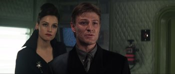 Movie still from “GoldenEye” (1995), directed by Martin Campbell – A person wearing a suit and a tie; Close Up shot, Low angle