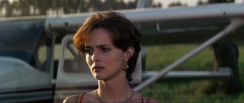 Movie still from “GoldenEye” (1995), directed by Martin Campbell – A person with short brown hair; Close Up shot, Over the shoulder angle