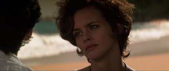 Movie still from “GoldenEye” (1995), directed by Martin Campbell – A woman's face in a dark room; Close Up shot, Over the shoulder angle