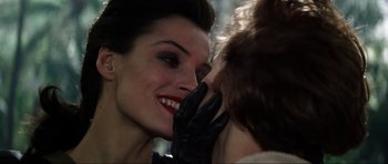 Movie still from “GoldenEye” (1995), directed by Martin Campbell – A woman with a black leather glove is talking to another woman; Close Up shot, Over the shoulder angle