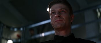 Movie still from “GoldenEye” (1995), directed by Martin Campbell – A person wearing a black shirt; Close Up shot, Low angle