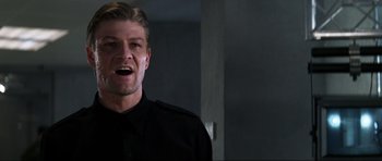 Movie still from “GoldenEye” (1995), directed by Martin Campbell – A person wearing a black shirt; Close Up shot, Low angle