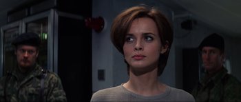 Movie still from “GoldenEye” (1995), directed by Martin Campbell – A person with short brown hair; Close Up shot, Over the shoulder angle