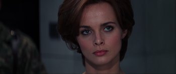 Movie still from “GoldenEye” (1995), directed by Martin Campbell – A woman's face with blue eyes; Close Up shot, Over the shoulder angle