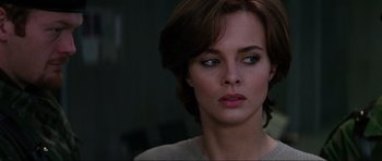 Movie still from “GoldenEye” (1995), directed by Martin Campbell – A person with short brown hair; Close Up shot, Over the shoulder angle