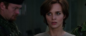 Movie still from “GoldenEye” (1995), directed by Martin Campbell – A person with short brown hair; Close Up shot, Over the shoulder angle