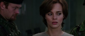 Movie still from “GoldenEye” (1995), directed by Martin Campbell – A person with short brown hair; Close Up shot, Over the shoulder angle