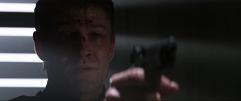 Movie still from “GoldenEye” (1995), directed by Martin Campbell – A person holding a cell phone; Close Up shot, Low angle