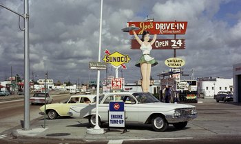 Movie still from “Goldfinger” (1964), directed by Guy Hamilton – An image of an old car parked at a gas station; Extreme Wide shot, High angle