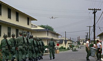 Movie still from “Goldfinger” (1964), directed by Guy Hamilton – A group of soldiers are marching down the street; Extreme Wide shot, Low angle