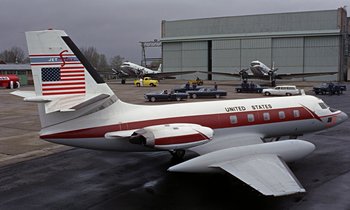 Movie still from “Goldfinger” (1964), directed by Guy Hamilton – An airplane parked at an airport with other planes in the background; Wide shot, Low angle