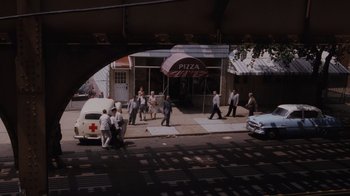 Movie still from “Goodfellas” (1990), directed by Martin Scorsese – A group of people walking down a street; Extreme Wide shot, High angle