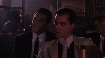 Movie still from “Goodfellas” (1990), directed by Martin Scorsese – A couple of men wearing suits and ties; Medium shot, Over the shoulder angle