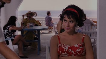 Movie still from “Goodfellas” (1990), directed by Martin Scorsese – A woman sitting at a table in front of the ocean; Medium shot, Over the shoulder angle