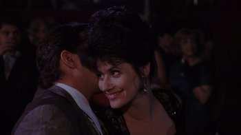 Movie still from “Goodfellas” (1990), directed by Martin Scorsese – A man and a woman are smiling at the camera; Close Up shot, Over the shoulder angle