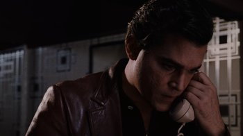 Movie still from “Goodfellas” (1990), directed by Martin Scorsese – A man talking on a phone while wearing a leather jacket; Close Up shot, Low angle