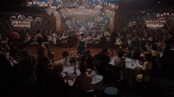 Movie still from “Goodfellas” (1990), directed by Martin Scorsese – A group of people sitting at tables in a room; Extreme Wide shot, High angle