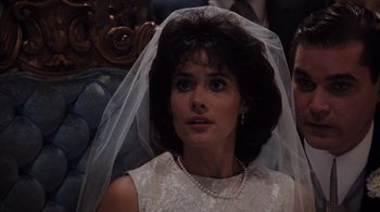 Movie still from “Goodfellas” (1990), directed by Martin Scorsese – A woman wearing a white dress and a veil; Close Up shot, Over the shoulder angle
