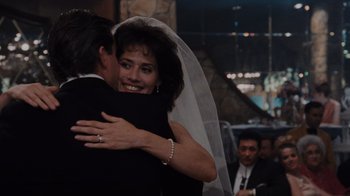 Movie still from “Goodfellas” (1990), directed by Martin Scorsese – A woman in a white veil hugging a man in a black suit; Close Up shot, Over the shoulder angle