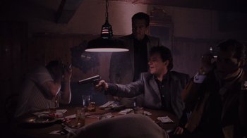 Movie still from “Goodfellas” (1990), directed by Martin Scorsese – A group of people sitting at a table with cards; Medium shot, Low angle