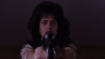 Movie still from “Goodfellas” (1990), directed by Martin Scorsese – A woman holding a gun in her hand; Close Up shot, Low angle