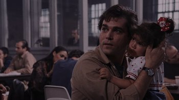 Movie still from “Goodfellas” (1990), directed by Martin Scorsese – A man holding a little girl in his arms; Close Up shot, Over the shoulder angle