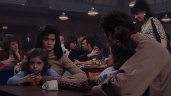 Movie still from “Goodfellas” (1990), directed by Martin Scorsese – A group of people sitting around a table; Medium shot, Over the shoulder angle