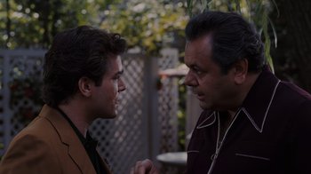 Movie still from “Goodfellas” (1990), directed by Martin Scorsese – Two men talking to each other in a yard; Medium shot, Over the shoulder angle