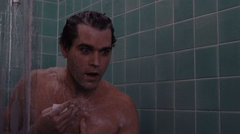 Movie still from “Goodfellas” (1990), directed by Martin Scorsese – A young man is taking a shower in the bathroom; Close Up shot, High angle