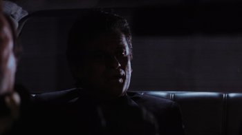 Movie still from “Goodfellas” (1990), directed by Martin Scorsese – A man sitting in a car in the dark; Close Up shot, Low angle