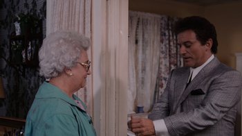 Movie still from “Goodfellas” (1990), directed by Martin Scorsese – An older woman and a younger man in a room; Medium shot, Over the shoulder angle