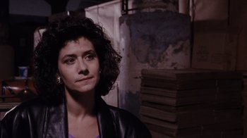 Movie still from “Goodfellas” (1990), directed by Martin Scorsese – A woman with curly hair wearing a leather jacket; Close Up shot, Over the shoulder angle