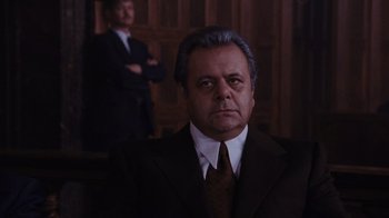 Movie still from “Goodfellas” (1990), directed by Martin Scorsese – A man in a suit and tie in front of another man in a suit and tie; Close Up shot, Low angle