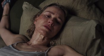 Movie still from “Goodnight Mommy” (2022), directed by Matt Sobel – A person laying on a couch; Close Up shot, High angle