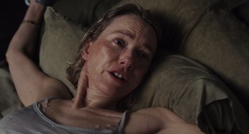 Movie still from “Goodnight Mommy” (2022), directed by Matt Sobel – A person laying on a bed; Close Up shot, Overhead angle