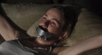 Movie still from “Goodnight Mommy” (2022), directed by Matt Sobel – A woman with duct tape around her mouth; Close Up shot, High angle